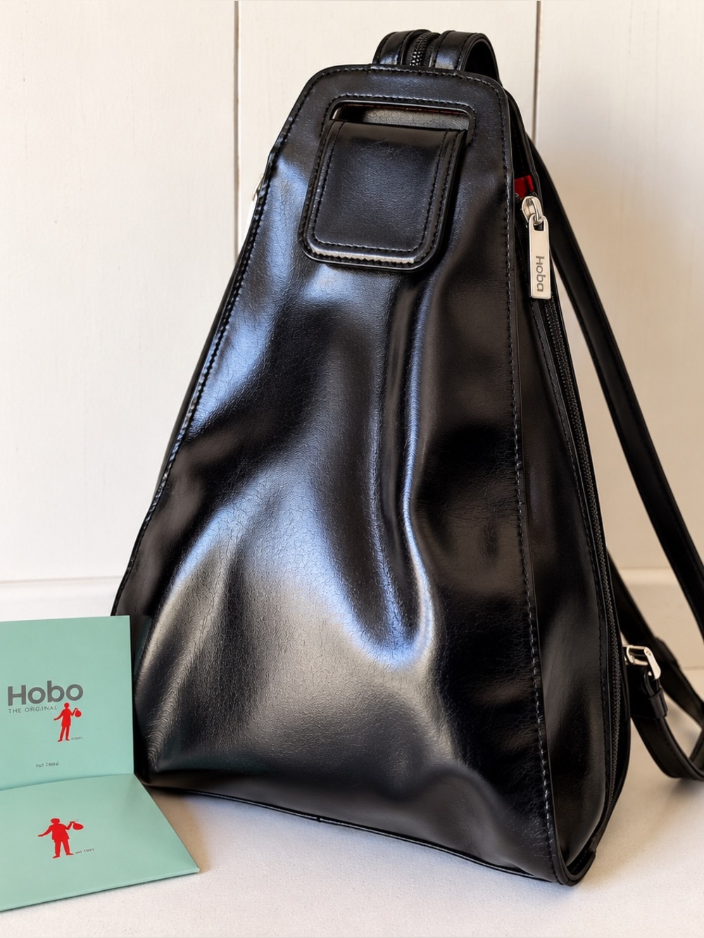 HOBO Black Leather Convertible Sling Backpack with Red Interior Lining